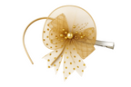 Gold hair bow with a clip on a white background