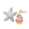 Starfish-shaped hair clip with sequins and a pink unicorn on a cupcake hair clip with rainbow and 'HAPPY' text on a white background.