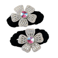 Two black hair scrunchies with silver flower-shaped embellishments on a white background