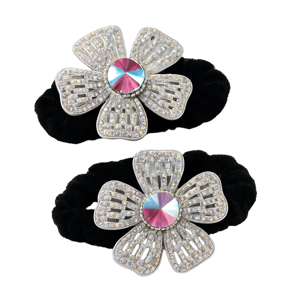 Two black hair scrunchies with silver flower-shaped embellishments on a white background