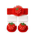 Set of red strawberry-themed headband and socks on a white background