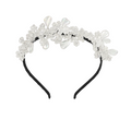 Decorative headband with crystals and pearls on a white background