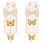 Two butterfly hair clips with decorative bows on packaging featuring cartoon bunny faces.
