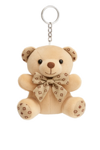 Beige teddy bear keychain with a bow on a white background