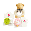 Teddy bear with a pink ice cream toy and green cookie toy on a white background