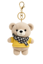 Teddy bear keychain with a yellow jacket and plaid scarf on a white background