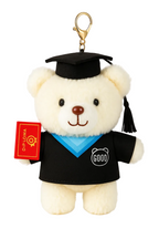 Graduation-themed teddy bear keychain with a diploma and 'GOOD' shirt on a white background