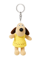 Plush dog keychain with a yellow dress on a white background