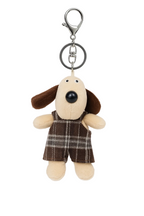 Dog-shaped keychain with plaid overalls on a white background