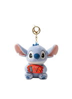 Plush keychain of a cartoon character holding an accordion on a white background