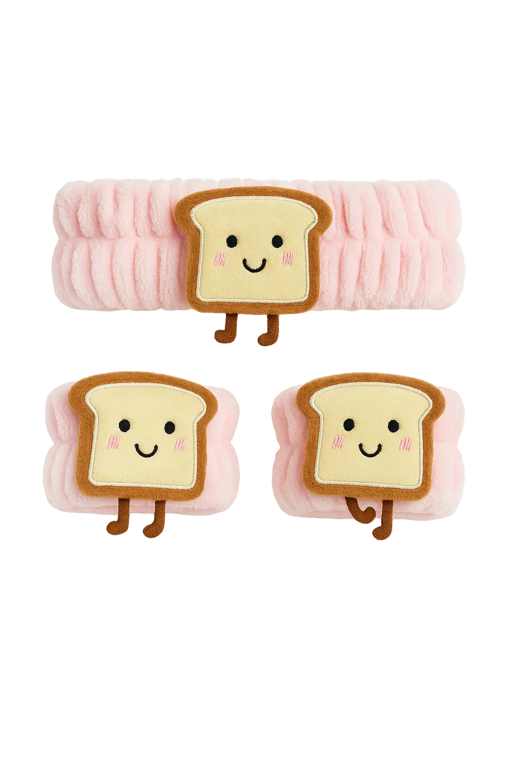 Three plush toys shaped like slices of bread with smiling faces on a white background