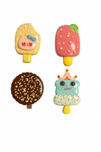 Four colorful ice cream-shaped hair clips on a white background