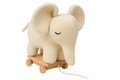 Knitted elephant toy with wooden base on a white background