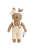 Crocheted deer toy with a white bib and flowers on a light background