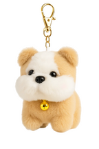 Plush dog-shaped keychain with a gold bell on a white background
