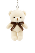 Small cream teddy bear with a brown 'Love' ribbon on a white background