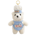 White teddy bear keychain with a blue checkered outfit and 'Lovely' hat on a white background