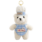 White teddy bear keychain with a blue checkered outfit and 'Lovely' hat on a white background
